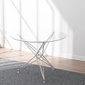 Round Transparent Glass Top Coffee Table With Metal Frame On Gray Rug And Sunlight Shadows