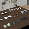Various Colored Cups And Bowls In Different Shapes Arranged On Wooden Table With Posters