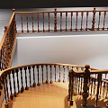 Modern Wooden Spiral Staircase with Handrail in Spacious Interior Space and Dark Door Nearby