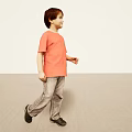 Man in orange T-shirt and gray jeans standing on light colored floor with light walls