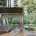 Wooden Pergola Structure In Park With Green Trees Lawn And Seating Benches