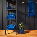 Bathroom Interior With Blue Towels Stacked On Shelves Hanging On Rod And Wooden Chair