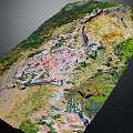 Natural Mountain Village Landscape With Red Roofs Lush Greenery And Hilly Terrain