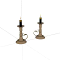 Ornate Metal Candlesticks With Lit Black Candles And Carved Handles Design