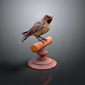 Small Brown Bird Perched on Red Wooden Decorative Base Isolated on Dark Background