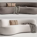 Modern Curved Multi Seater Sofa In Neutral Tones With Brown Pillows And Plaid Blanket