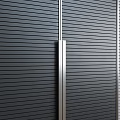 Modern Wardrobe Design With Vertical Striped Panels And Metal Handles