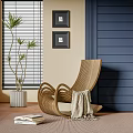 Modern Wicker Lounge Chair With Beige Blanket Navy Blue Wall And Black Framed Paintings