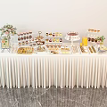 Elegant Food Display Table With Various Desserts Floral Decor And White Tablecloth