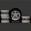 Car Tires Stacked With Metallic Wheel Rim On Dark Reflective Surface