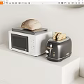 Modern Kitchen Appliances On White Counter With White Microwave Black Toaster And Bread