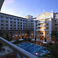 Elegant Mediterranean Style Office Building with Courtyard Swimming Pool Palm Trees and Evening Lights