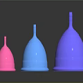 Three Different Colored Menstrual Cups Arranged In A Row On Dark Background