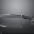 Sharp Metal Blade Knife With Black Handle And Silver Accents On Reflective Surface