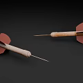 Two Darts With Red Flights Wooden Shafts And Metal Tips On Dark Background