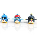 Cute Cartoon Bird Figurines With Blue Red Hat And Black Designs On Shiny Surface