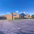 Modern Museum Building With Brick Glass Facade Large Windows Open Plaza Blue Sky Green Trees