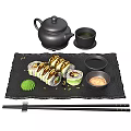 Sushi Rolls On Black Slate Tray With Chopsticks Soy Sauce Wasabi Teapot And Perilla Leaf