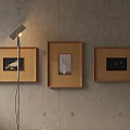 Concrete Wall Interior With Three Framed Pictures And Modern Floor Lamp