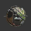 Round Metal Frame Mirror Reflecting Green Plants And Building Structures