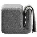 Soft Gray Upholstered Ottoman with Cozy Knitted Blanket in Modern Living Room
