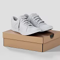 White Lace Up Sneakers Placed On A Brown Cardboard Box
