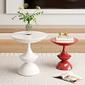 White and Red Round Accent Tables Featuring Vase Plant Gold Decor and Book