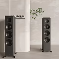 Modern Floor Standing Speakers With White Cylindrical Background And Green Plants
