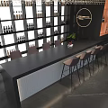 Modern Bar Interior With Black Countertop Wine Shelves Bar Stools And Potted Plant