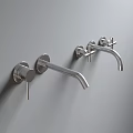Two Modern Chrome Wall Mounted Faucets With Handles On Grey Wall Background
