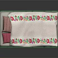 Single Bed with Green Frame Yellow Accents Pink Pillows and Floral Embroidered Quilt