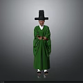 Man in Traditional Green Robe Wearing Black Tall Hat Holding Object Against Gray Background