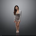 Smiling Woman With Long Hair In Gray Dress And Light Gray Cardigan Against Gray Background