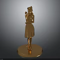 Golden Female Statue Standing On Circular Base With Hand Near Face