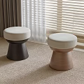 Round Upholstered Stools With Wooden Legs In Different Colors And Carpeted Room