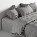 Modern Double Bed with Linen Bedspread and White Pillows in Neutral Toned Bedroom Interior