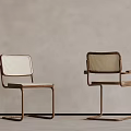 Modern Woven Chairs With Metal Frames Against Gray Wall And Neutral Floor
