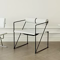 Modern Leisure Chair With Black Metal Frame White Cushion Rolled Backrest And Wooden Floor