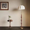 Vintage Floor Lamp With Scalloped Shade Near Side Table And Decorative Wall Art