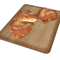 Three Freshly Baked Heart Shaped Bread Rolls on Wooden Cutting Board