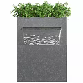 Modern Garden Accent Featuring Black Water Fountain Structure With Green Plants And Flowing Water