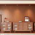 Wooden Sideboard with Glass Doors and Decorative Items Near Plant and Side Table