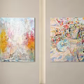 Two Vibrant Colorful Abstract Paintings Hanging on Light Colored Wall