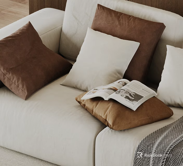 Brown And White Decorative Pillows On Beige Sofa With Open Magazine 3d model 