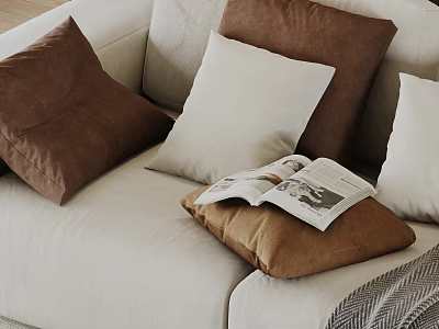 Brown And White Decorative Pillows On Beige Sofa With Open Magazine 3d model