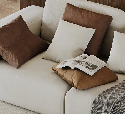 Brown And White Decorative Pillows On Beige Sofa With Open Magazine 3d model