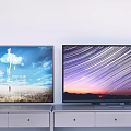 Two Televisions on White TV Stands with Scenic Displays of Sky Grass and Star Trails