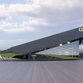 Modern Sales Office Building With Angled Roof COHI Signage Glass Curtain Wall And Landscaped Lawn