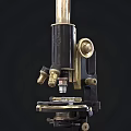 Three Vintage Medical Microscopes with Classic Brass and Black Medical Equipment Design