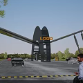 Modern Entrance Gate With LOGO Featuring Vehicles Passing Through Outdoor Area Surrounded By Trees